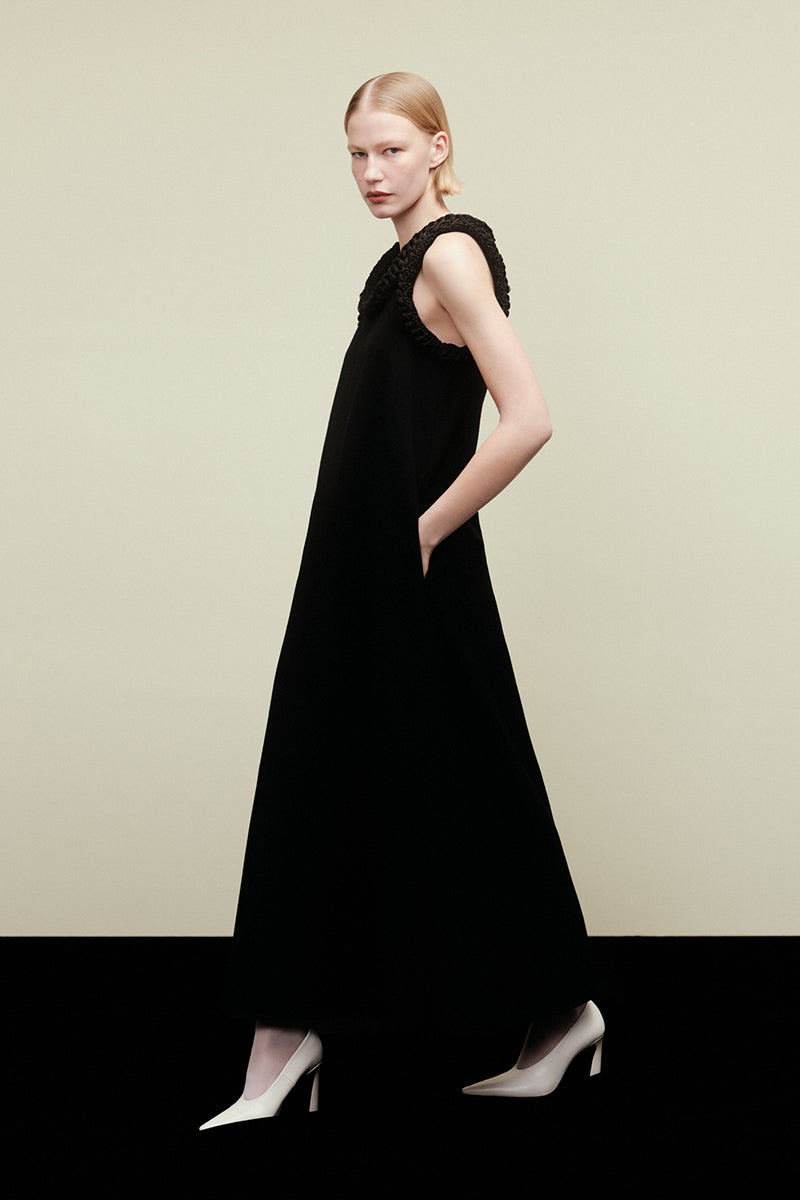 Elegant DELEGAN KOSSA maxi dress displayed in a campaign image, featuring flowing fabric and a stylish, full-length design.
