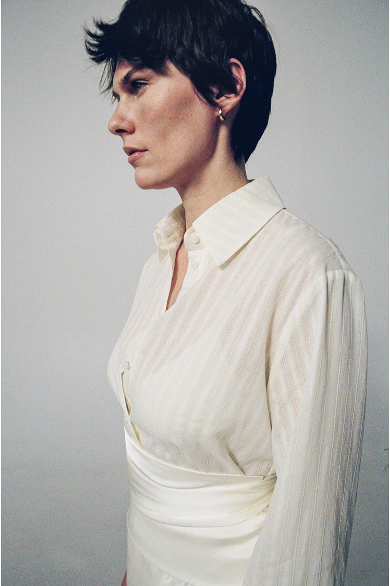 Milk textured shirt by DELEGAN, showcasing a close-up of the fabric with a smooth, textured milk-inspired design in a stylish shirt.