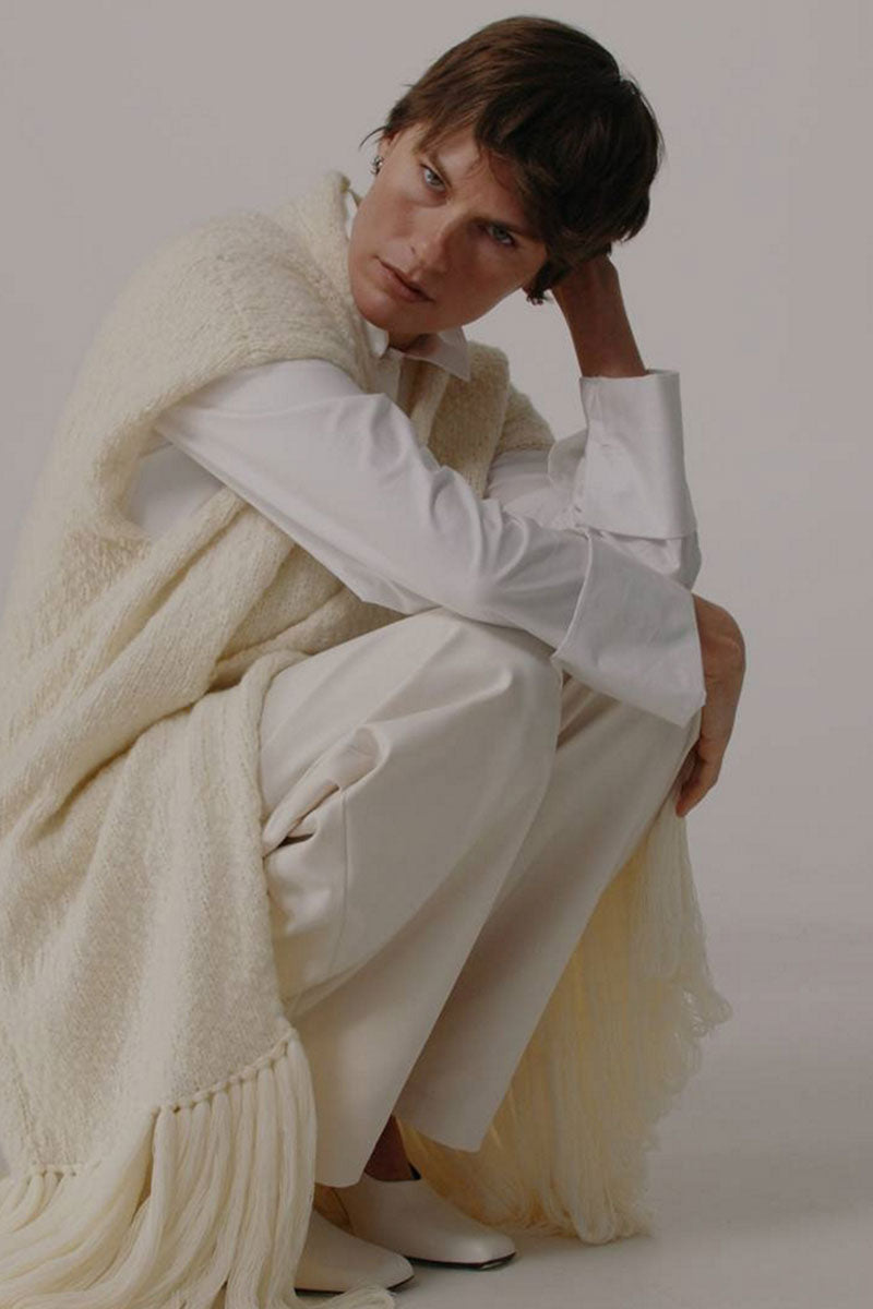 Textured knit vest from DELEGAN, a stylish cardigan with a cozy, patterned knit design and a fitted silhouette.