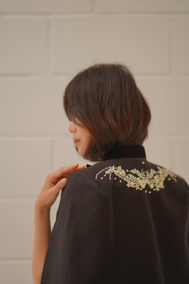 Nadya Shah Cape Nocturne jacket with flowing black fabric, stylish design, and elegant silhouette for sophisticated fashion.