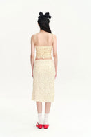 Beige Nora tank top by Chictopia, sleeveless top with a relaxed fit, displayed on a hanger against a neutral background.