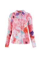 Pink floral smocked shirt by Chictopia with ruffled sleeves and a fitted bodice, displayed on a neutral background.