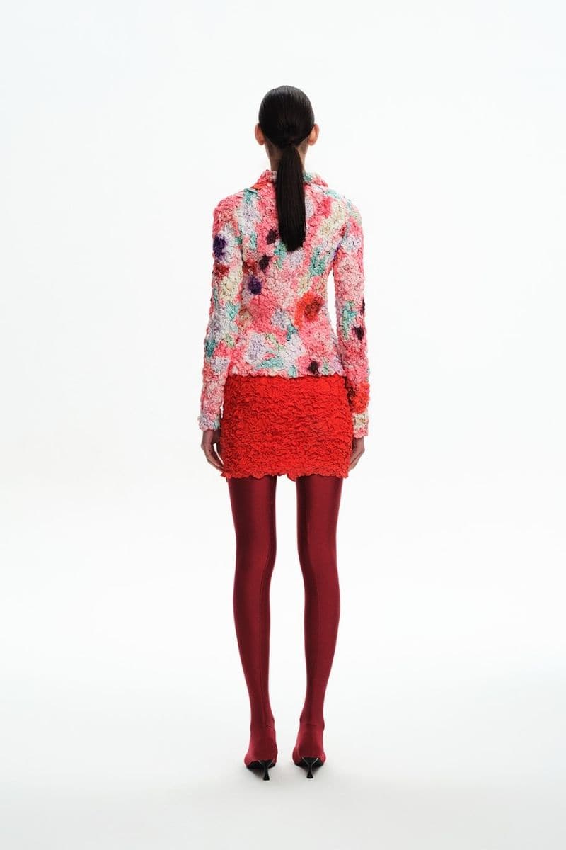 Pink floral smocked shirt by Chictopia featuring a fitted bodice, short puffed sleeves, and a vibrant floral pattern.
