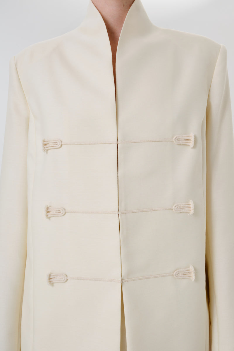 Dark-colored still form blazer by DELEGAN, showcasing sleek tailored design and stylish lapel detail.
