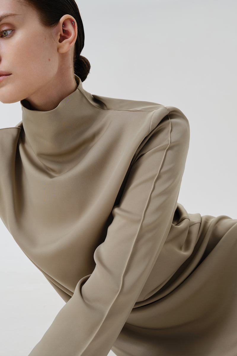 Close-up of DELEGAN Olive Sheen Midi Dress fabric showing smooth, shiny olive green material with elegant drape and subtle sheen.