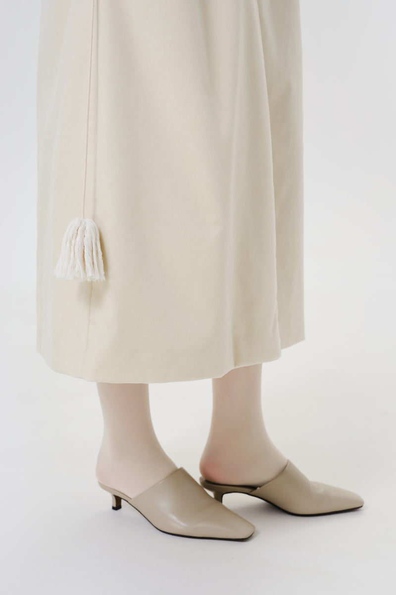 Close-up of a DELEGAN ivory velvet coat showing soft fabric texture and elegant design details.