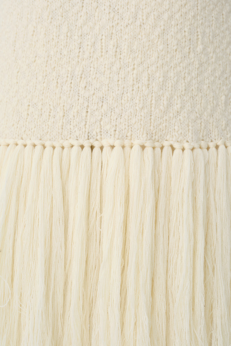 Close-up of a textured knit cardigan vest by DELEGAN, showcasing the detailed knit pattern and comfortable fit.
