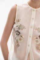 Close-up of DELEGAN silk blossom embroidered shirt showing intricate floral embroidery and smooth silk fabric details.