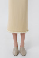 Close-up of a DELEGAN wool midi skirt showing soft, textured fabric and elegant stitching details.