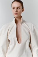 Close-up of the gray-beige structure shirt by DELEGAN, showing the textured fabric and tailored collar.