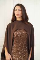 Close-up of Joanna Andraos CULT MIA X Joanna Andraos gown featuring a fitted corset dress with a detachable cape.
