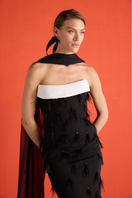 Close-up of a black feather corset gown by Joanna Andraos, showcasing intricate feather details and elegant design.