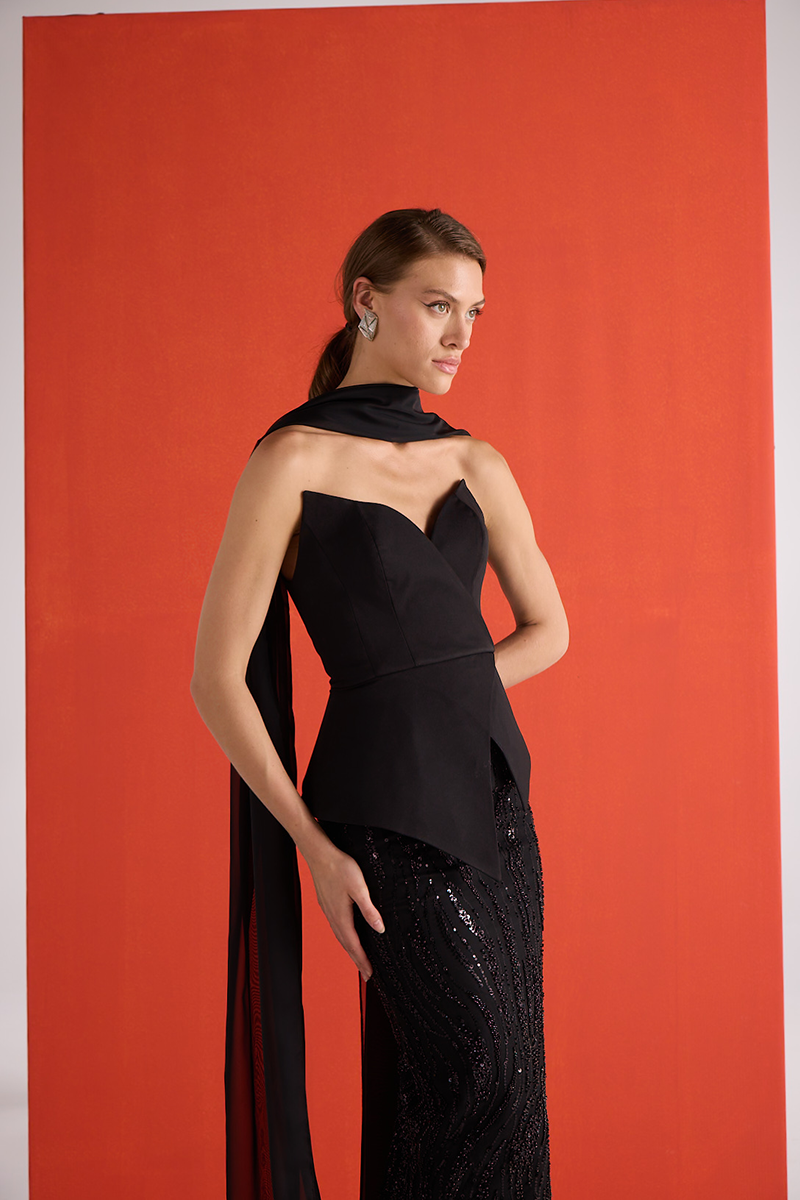 Close-up of Joanna Andraos black embroidered corset co-ord set showing detailed embroidery and fitted bust design.