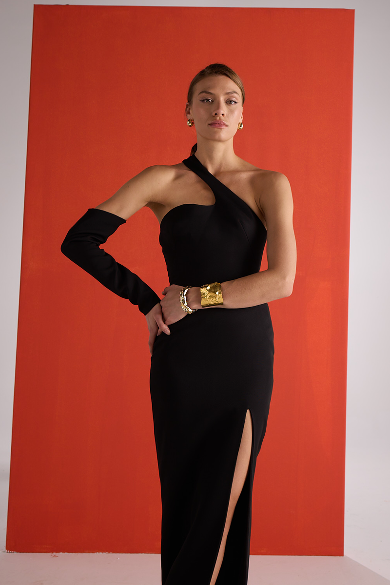 Close-up of Joanna Andraos black gown with detachable sleeves, showcasing elegant fabric and detailed design.