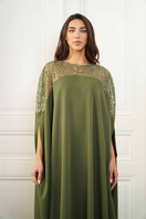 Close-up of Joanna Andraos embroidered olive green gown showcasing detailed floral embroidery and luxurious fabric.