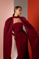 Close-up of a Burgundy Twist Gown by Joanna Andraos, showcasing elegant fabric and intricate twisted design detail.