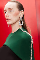 Joanna Andraos black co-ords set with matching top and pants, featuring a detachable emerald cape for a stylish look.