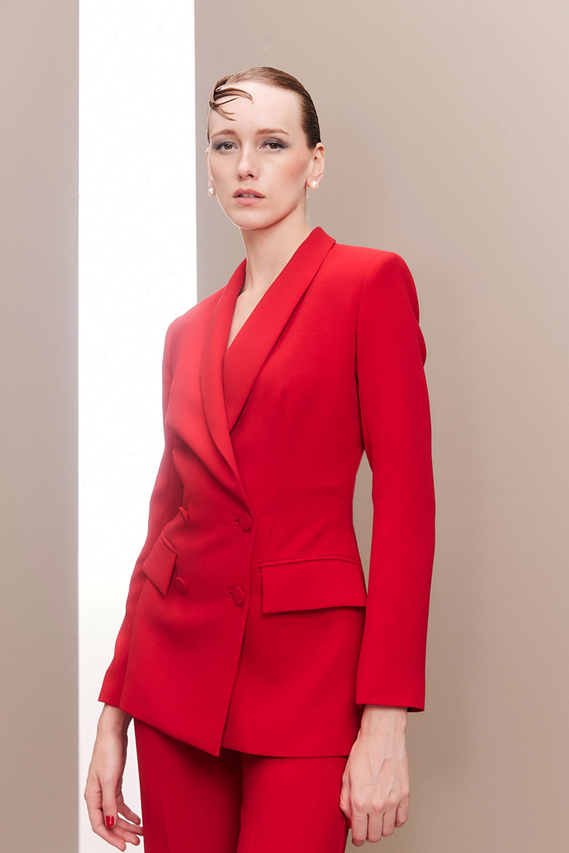 Close-up of Joanna Andraos red hourglass co-ord suit set featuring fitted fabric and stylish design details.