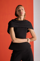 Black crepe two-piece co-ord set with draped cape from Joanna Andraos, featuring detailed fabric and elegant design.