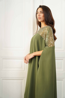 Close-up of the Joanna Andraos embroidered olive green gown showcasing intricate floral embroidery details.