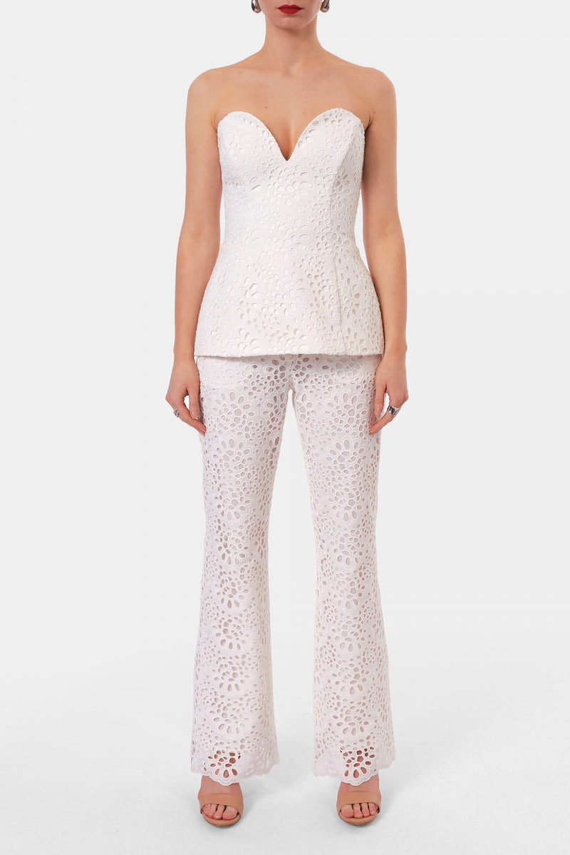 Off-white embroidered corset top by AGGI by HALEWSKI, featuring intricate embroidery and a fitted, stylish design.