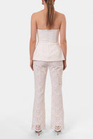 Off-white embroidered Lamia corset top by AGGI by HALEWSKI, showcasing intricate embroidery and fitted design.