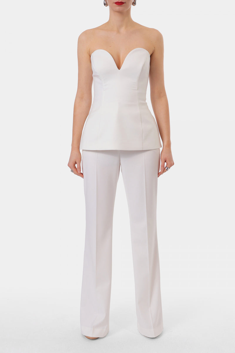 Off-white Lamia Corset top by AGGI by HALEWSKI, featuring structured design and adjustable straps, shown on a model.