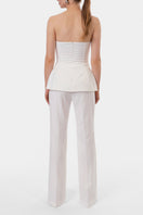 Off-white Lamia corset top by AGGI by HALEWSKI, featuring fitted design and structured details, displayed on a mannequin.