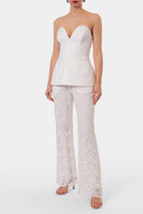 Off-white Lamia corset top by AGGI by Halewski, featuring structured design and adjustable straps, shown on a model.
