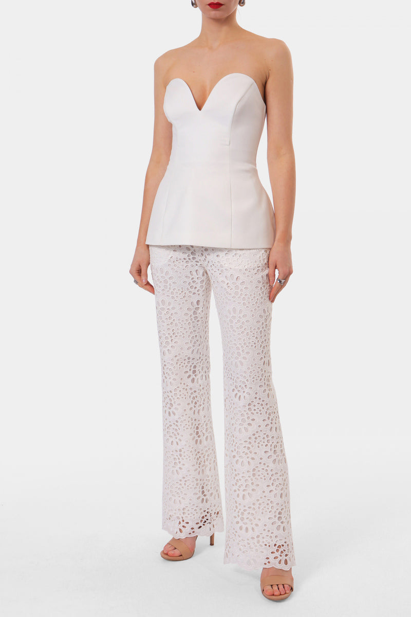 Off-white Lamia corset top by AGGI by Halewski, featuring structured design and adjustable straps, shown on a model.