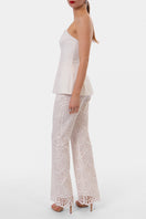 Off-white LAMIA corset top by AGGI by HALEWSKI featuring structured design and adjustable straps on a neutral background.