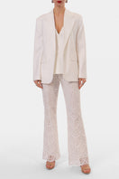 Off-white Lamia corset top by AGGI by HALEWSKI, featuring structured design and adjustable straps, styled on a model.