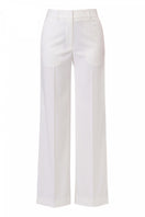 Off-white pants by AGGI by HALEWSKI, featuring a stylish fit and modern design, shown on a model in a casual setting.