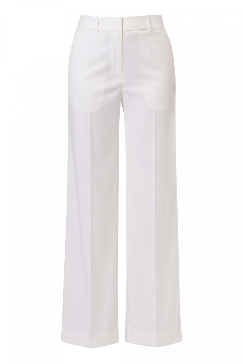 Off-white pants by AGGI by HALEWSKI, featuring a stylish fit and modern design, shown on a model in a casual setting.