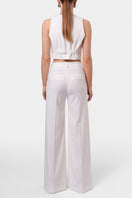 Off-white AGGI by HALEWSKI FRANZI pants with a relaxed fit and stylish design, shown in a front view.