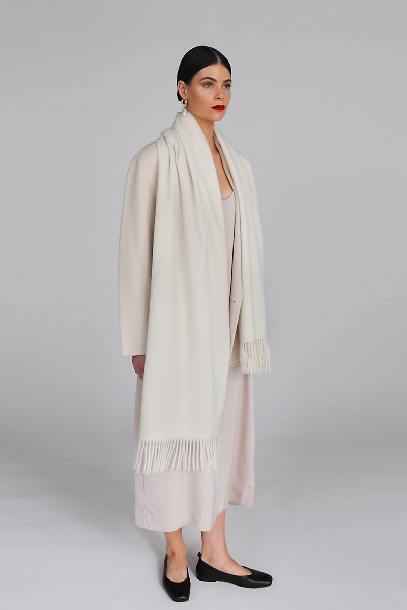 Aethera Helena cashmere shawl in white, draped elegantly to showcase soft, luxurious fabric and classic style.
