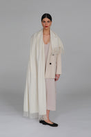 Aethera Helena cashmere shawl in Blanc, soft and elegant, draped showcasing its luxurious texture and lightweight design.