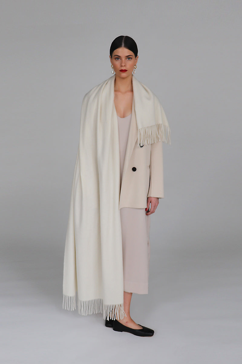 Aethera Helena cashmere shawl in Blanc, soft and elegant, draped showcasing its luxurious texture and lightweight design.