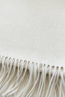 Aethera Helena cashmere shawl in blanc, showcasing soft, luxurious fabric draped elegantly for cozy, stylish wear.