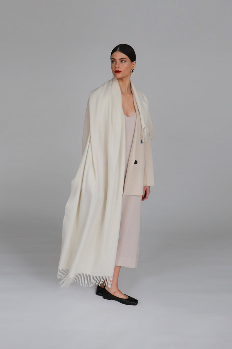 Aethera Helena cashmere shawl in Blanc, draped elegantly, showcasing soft, luxurious cashmere fabric and stylish design.