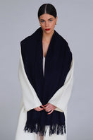 Aethera Helena cashmere shawl in nero, elegantly draped, showcasing soft black cashmere fabric perfect for stylish warmth.