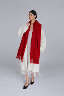 Aethera Serene lambswool shawl in crimson draped elegantly, showcasing soft texture and vibrant color for stylish warmth.