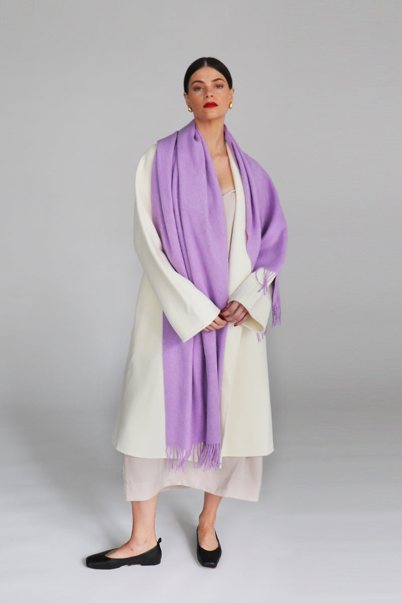 Soft mauve Aethera Serene lambswool shawl draped elegantly, showcasing its cozy texture and lightweight design.
