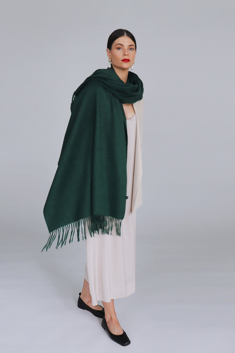 Aethera Serene lambswool shawl in vibrant chartreuse color, draped to showcase its soft, cozy texture and elegant design.