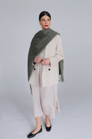 Aethera Serene Lambswool Shawl in soft celadon green, draped to showcase its cozy, lightweight wool texture.
