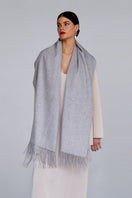 Aethera Helena cashmere shawl in marle, draped loosely to showcase soft, textured fabric and versatile style.