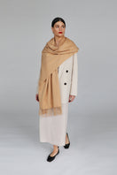 Aethera Helena cashmere shawl in camel color, draped elegantly to showcase soft, luxurious cashmere fabric and stylish design.