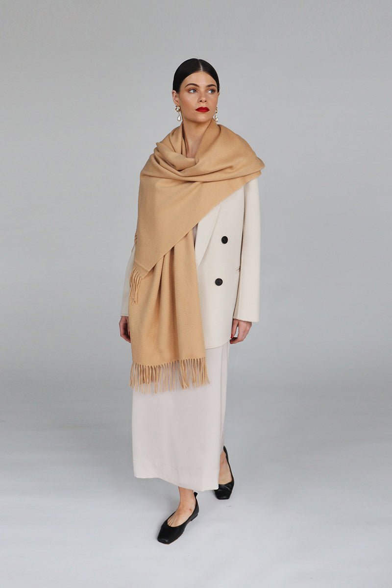 Aethera Helena cashmere shawl in camel color, draped elegantly to showcase soft, luxurious cashmere fabric and stylish design.