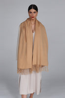 Aethera Helena cashmere shawl in camel, draped elegantly showcasing soft, luxurious cashmere fabric and stylish design.