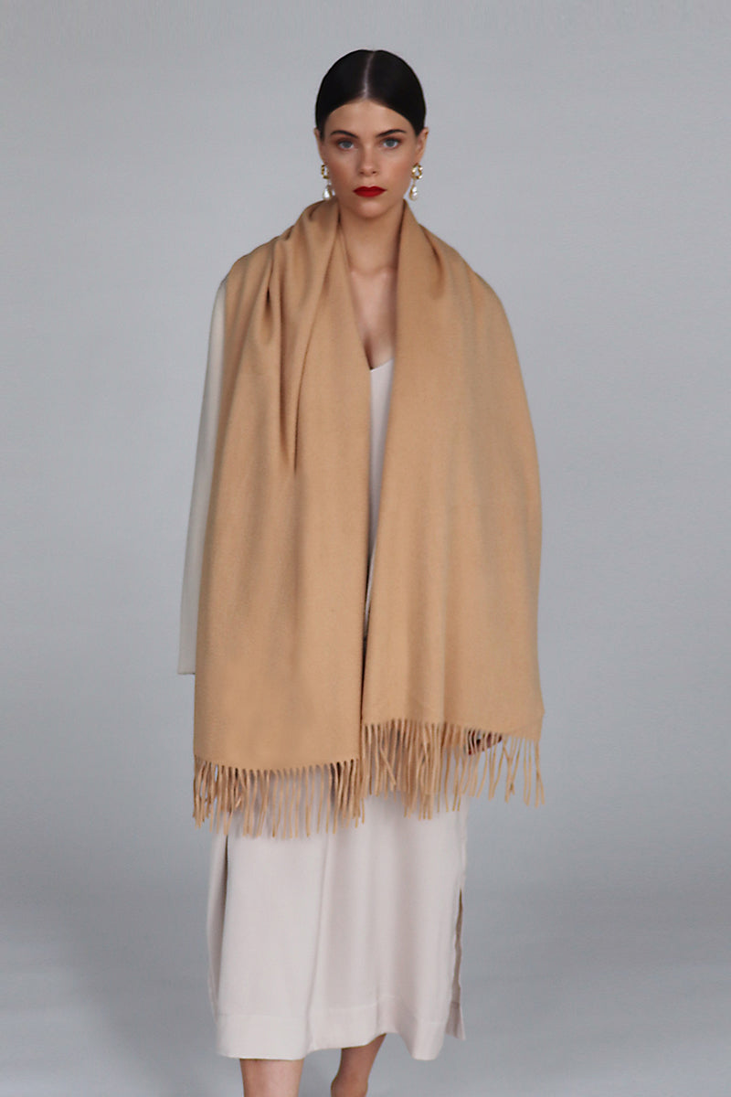Aethera Helena cashmere shawl in camel, draped elegantly showcasing soft, luxurious cashmere fabric and stylish design.